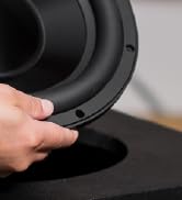 partial view of a hand holding a speaker