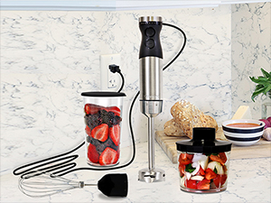 Kenmore hand blender and attachments with food on a marbled white kitchen counter