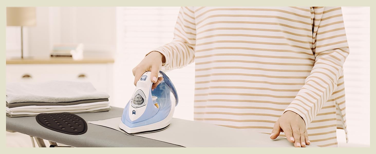 A woman ironing with the iron rest pad