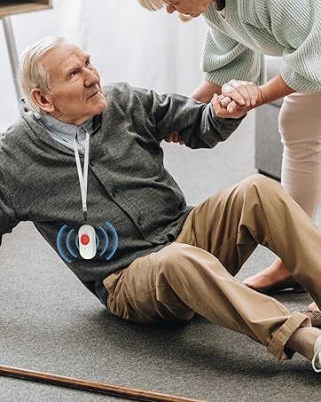 Medical alert device worn on grey sweatshirt, with wireless signal indicator, shown during assistance scenario on carpeted floor.