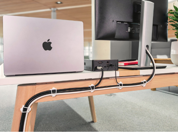 Proudct holding cables behind desk.