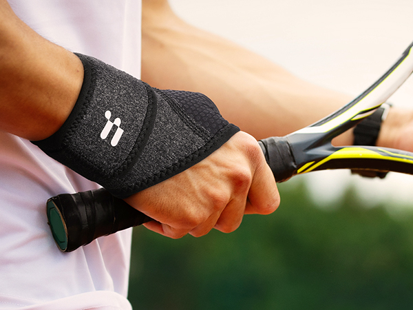 a person wearing a wristband and a tennis racket