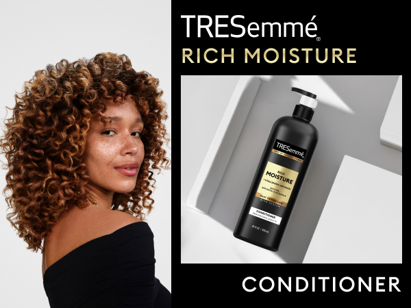 Model with bouncy curls beside TRESemmé Conditioner on top of a geometrical, sleek surface.