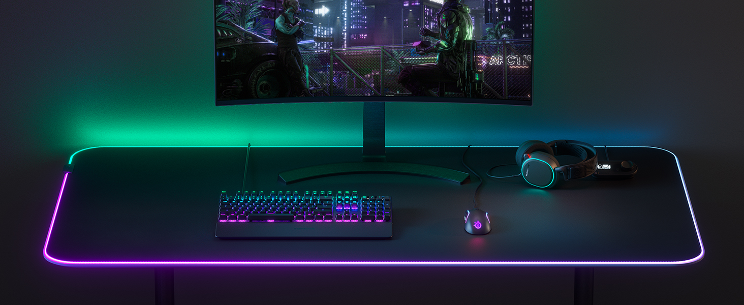 -SteelSeries desk setup with keyboard, mouse, headset, mousepad, and monitor