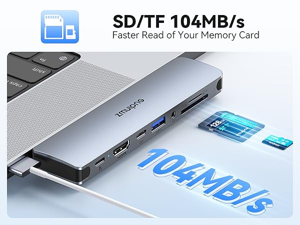 Slim aluminum USB hub featuring SD/TF card reader with 104MB/s transfer speed, HDMI port, and USB ports, shown connected to laptop keyboard.
