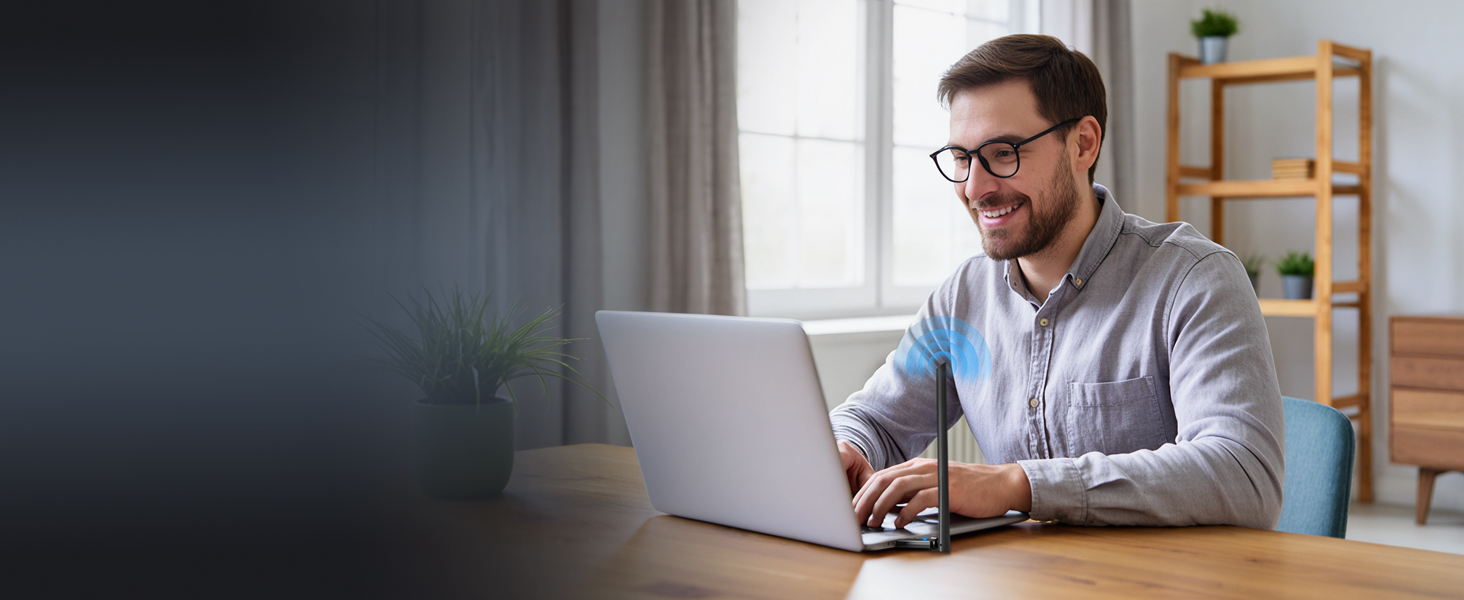 A Man Is Using a Laptop and Enjoying Fast Internet Access with the Linux USB WiFi Adapter