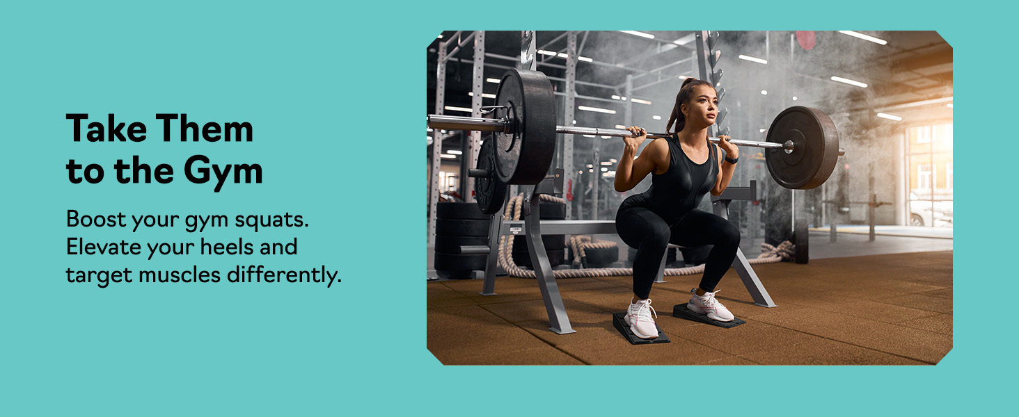 Woman doing barbell squats on slant board calf stretcher and squat wedge block at the gym