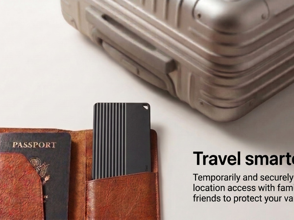 Slim tracker card placed beside a passport and travel suitcase.