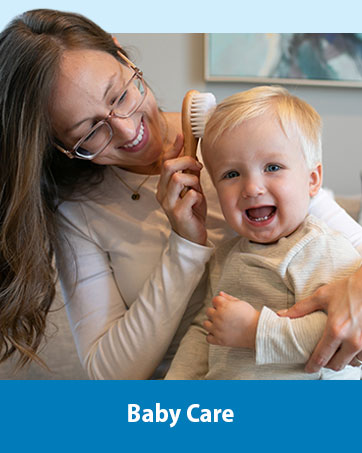 Mom brushing toddler&amp;#39;s hair with hair brush