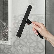 lack shower squeegee in hand on wet glass, modern matte design with minimalist look