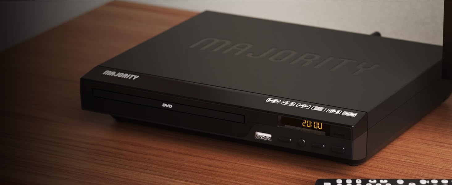 Majority region free dvd player on wooden shelf in living room. Display shows time