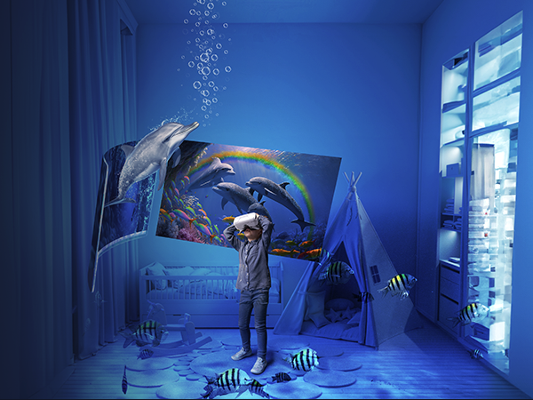 Virtual reality gaming scene in blue-lit room showing underwater theme with projected dolphin imagery and floating bubble effects.