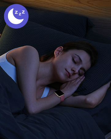 Woman sleeping on dark bedding, wearing white top and fitness tracker. Purple moon icon with 'Zzz' in corner suggests sleep tracking feature.