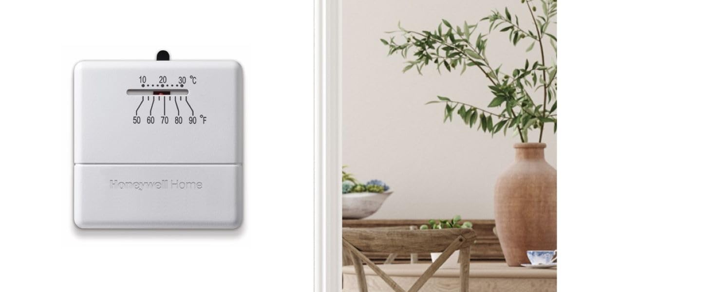 Manual thermostat on wall next to table with plant