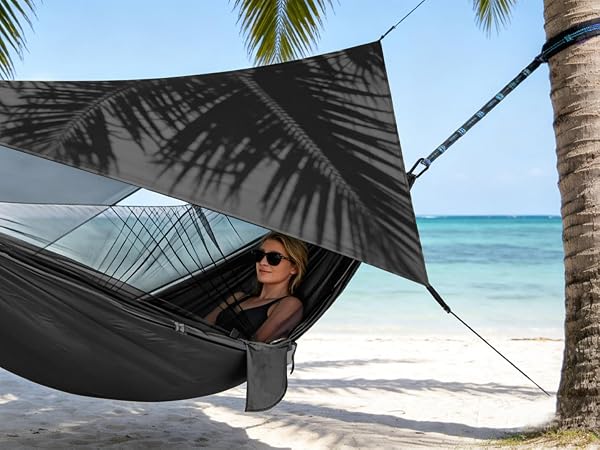 Black hammock suspended between palm trees on tropical beach with turquoise water and white sand. Multiple views showing hammock setup and usage.