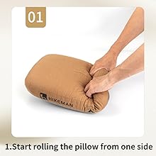 Hands demonstrating how to roll a cylindrical pillow or cushion. Step 1 of a guide showing the start of the rolling process from one side.