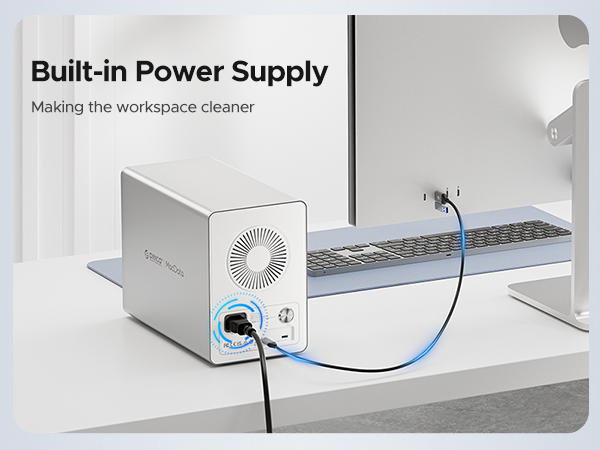 Compact white power supply unit with built-in fan design, connected to a power strip on desk, featuring 'Built-in Power Supply' text header.