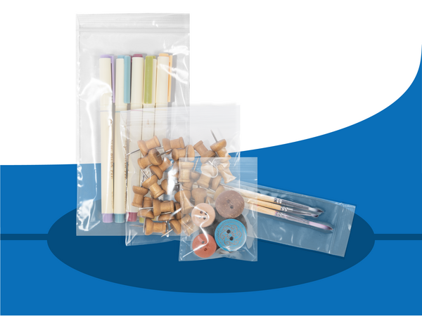 Four sizes of our 2 Mil zipper bags with markers, pins, buttons, and brushes sealed inside them.