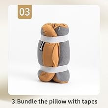 Gray and tan cylindrical pillow secured with white straps or tapes, demonstrating a bundling or storage technique.