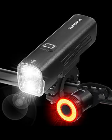 Bicycle light set featuring a bright white front headlight and circular red rear light with illuminated ring design, both mounted on handlebars.