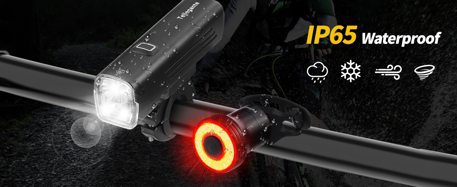 Bicycle light set with white front light and red rear light mounted on handlebars. Front light illuminated, rear light showing circular LED pattern. Text indicates IP65 waterproof rating.