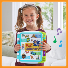 Girl holding up A to Z Learn with Me Dictionary, shown with notes to illustrate music.