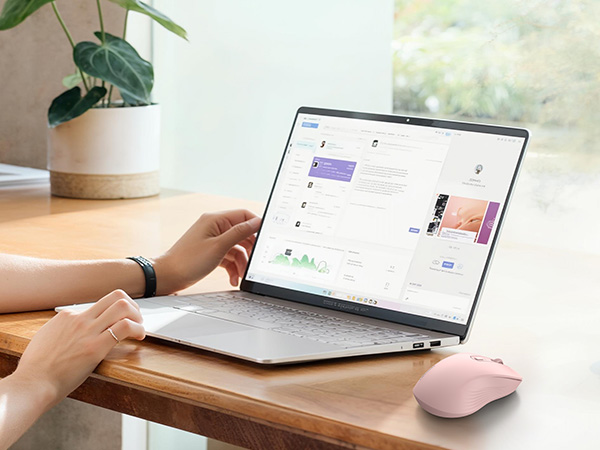 Series of images showing hands interacting with laptop and mobile devices, demonstrating cross-device functionality in well-lit workspace setting.