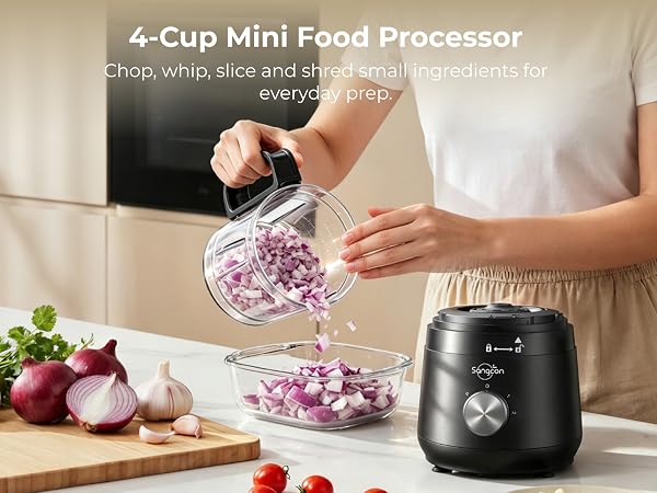 Person pours chopped red onion from the 4-cup bowl beside the motor base and fresh produce