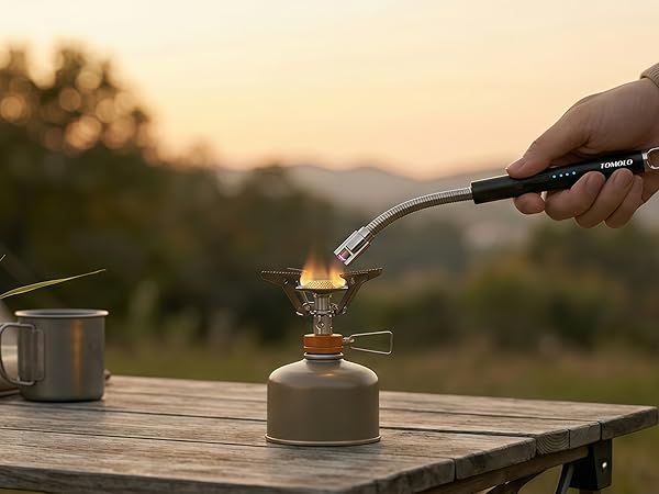 Electric arc lighter lighting a gas stove in kitchen