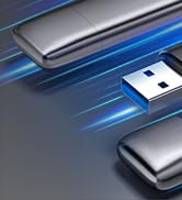 Multiple metallic USB flash drives against a blue background with motion blur, suggesting speed or data transfer.