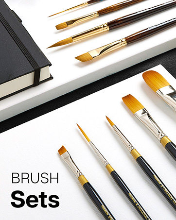 Brush Sets laying on top of canvases