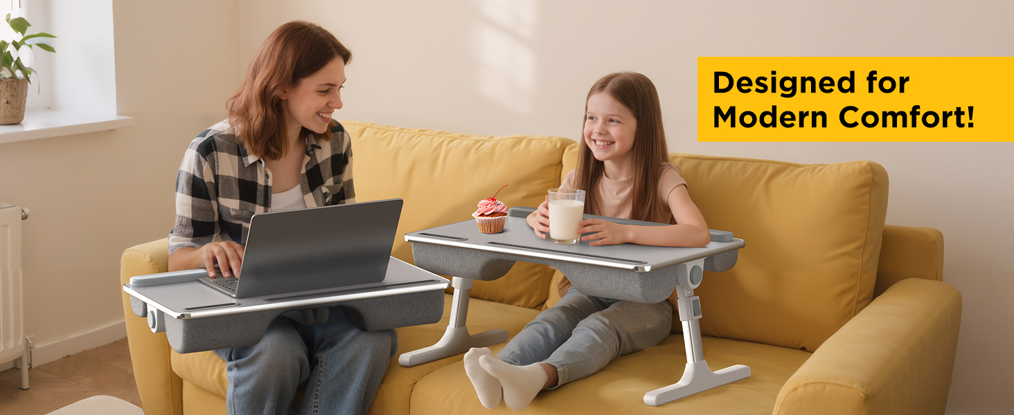 Mother and daughter using height-adjustable couch laptop desks for work and snacks.