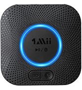 Square black Bluetooth speaker with textured surface. Blue illuminated ring around central button displaying '1Mii' logo. Additional control buttons visible.