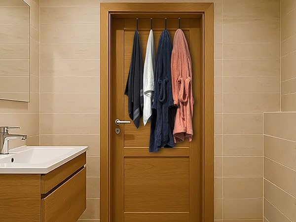 Two bath towels and two bathrobes hang from four hooks on bathroom door with hook size