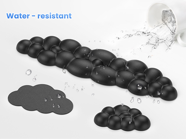 Water-resistant black textured mats in various shapes. Droplets visible on surfaces. Water splash in background demonstrates water-repellent properties.