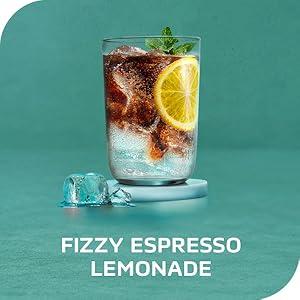 A tall glass of NESCAFÈ Espresso Concentrate, lemonade &amp; ice with a lemon. Fizzy espresso lemonade