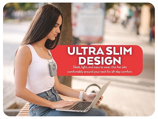 Woman working on laptop wearing gray O2Cool Rechargeable Necklace Fan, Ultra Slim Design 