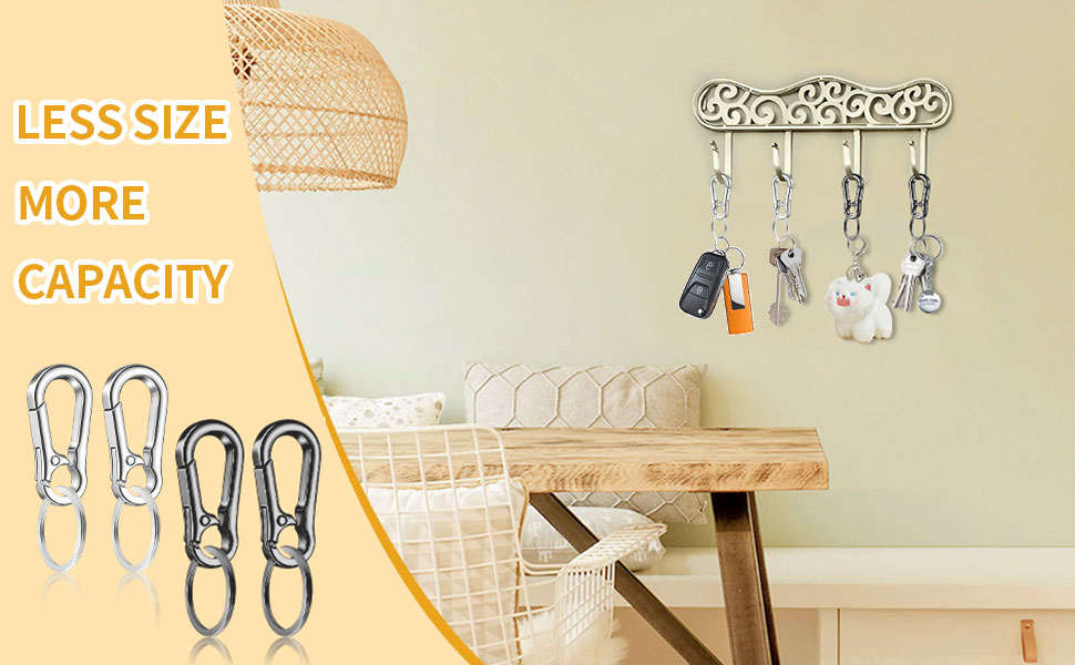 Four keychains hanging on a key holder.