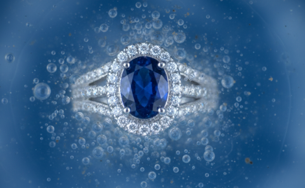 Image of jewelry submerged in blue solution.