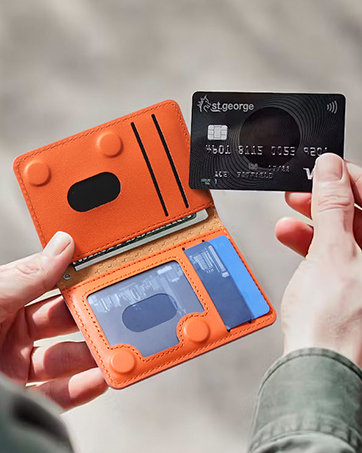 Sequence showing hands demonstrating usage of an orange and black card holder or wallet device with sliding mechanism.
