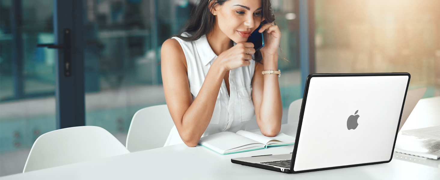 woman talking on the phone at a laptop