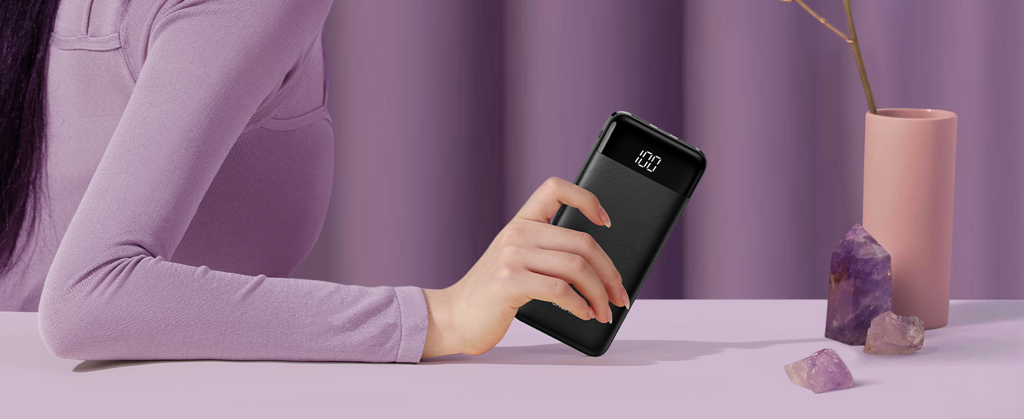 a woman holding a smartphone in her hand.