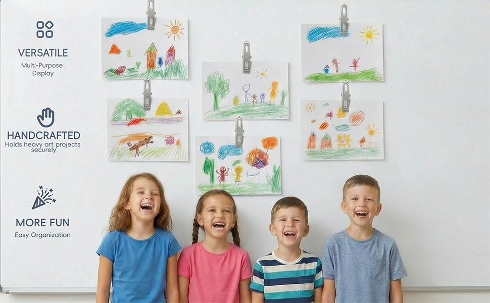 Teacher and students using clips to display colorful artwork on a whiteboard.