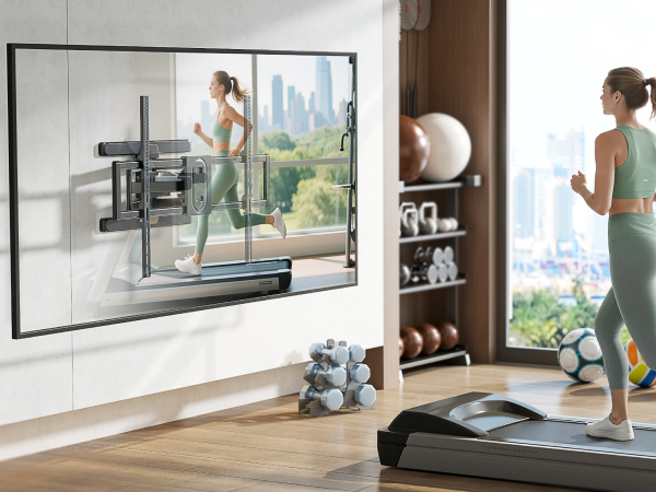 Wall-mounted TV showing a woman running on a treadmill. A woman in green activewear uses a treadmill in a home gym setting with city view.
