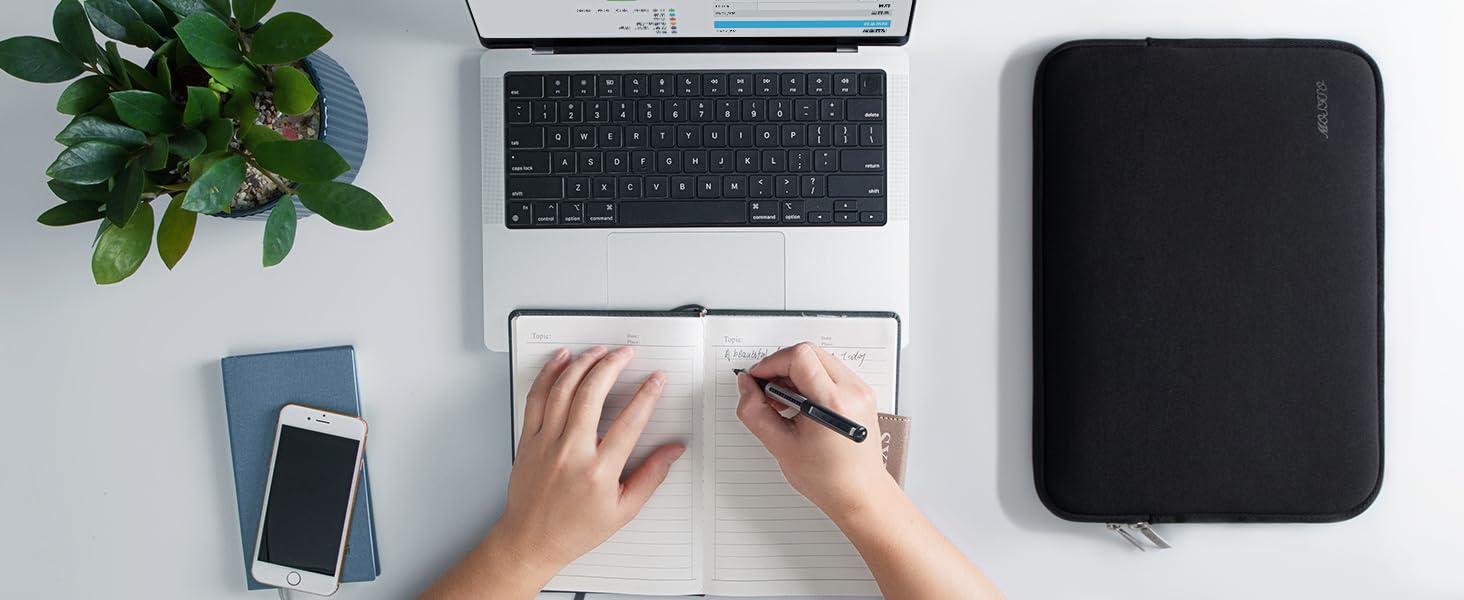 a person writing on a notebook with a pen