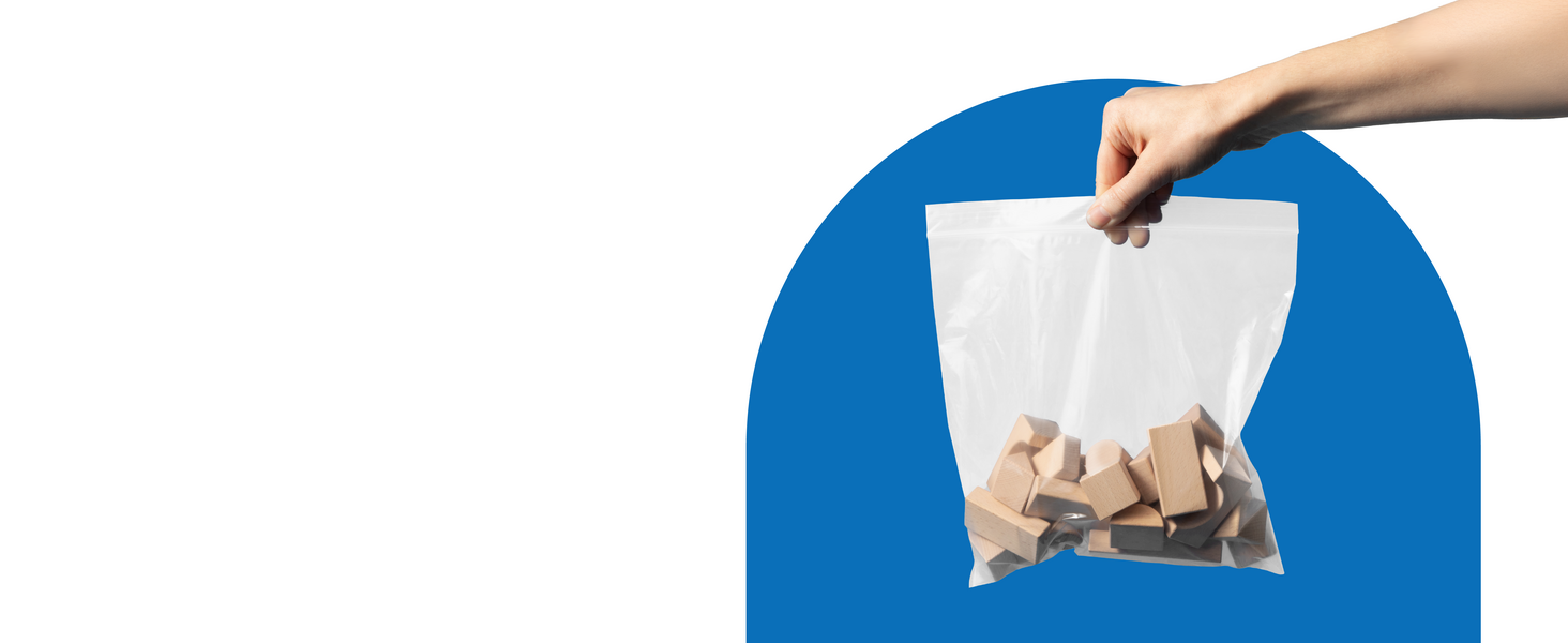 An extended hand holds a bag of wood building blocks in a poly bag over a blue and white background.