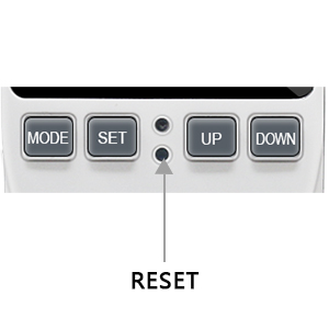 Close-up of a control panel with MODE, SET, UP, and DOWN buttons. Features a RESET function indicated by an arrow.