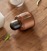 Close-up of a wooden surface with what appears to be a small metallic or glass object partially visible in the frame.