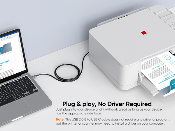 a laptop and printer on a desk.