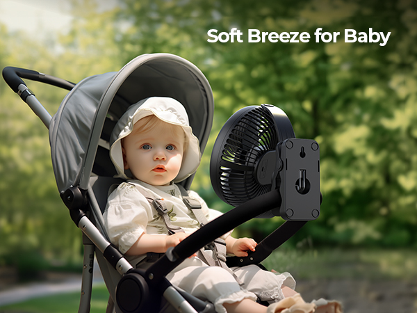 Portable fan attached to a baby stroller, providing a soft breeze for the infant. Stroller in outdoor setting with greenery in background.